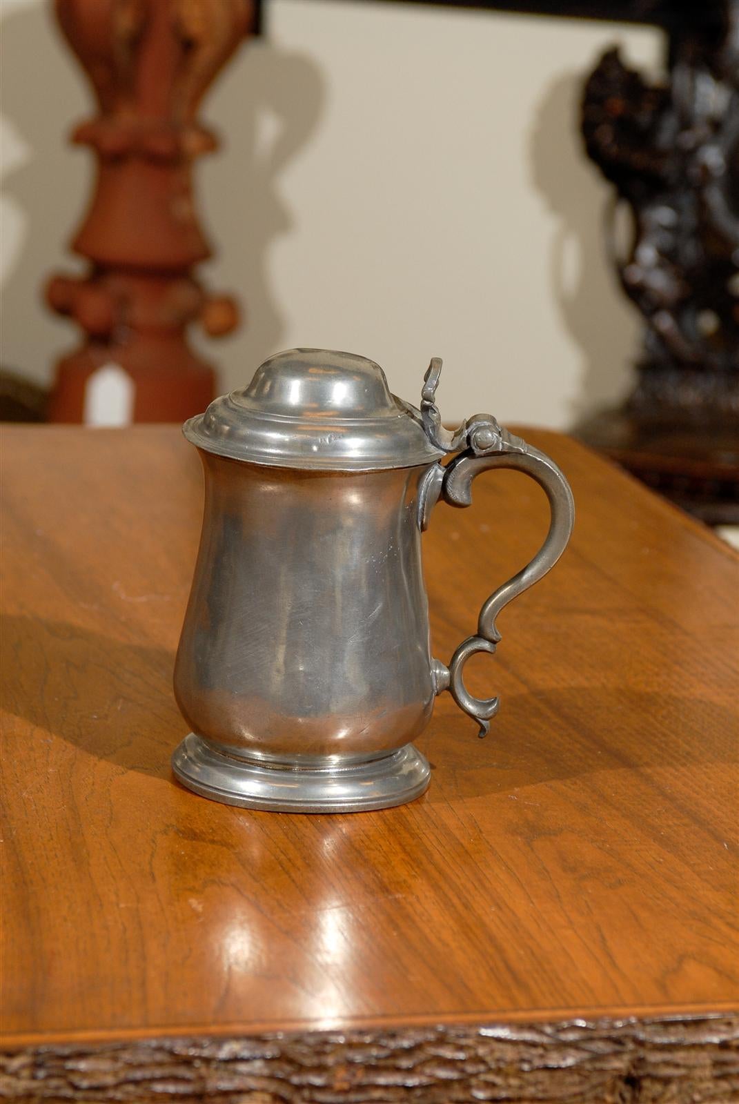 This is a charming English pewter flagon that holds 1 quart. It was hand hammered by Townsend in London c. 1730 - 1750.  Pewter of this kind was used for eating, drinking, and celebrating on a daily basis until the 19th century. This flagon has a