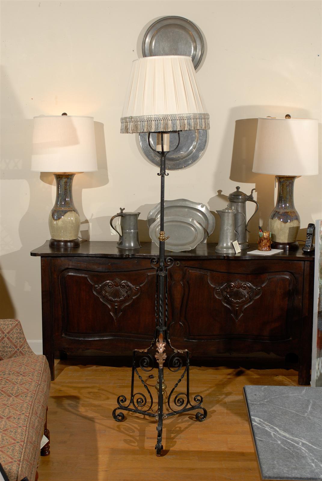 This is a floor lamp with copper leaves and intricate details on the base that travel up to the shade. The shade is handmade and has nice multicolored fringe and would be a great addition to any room.