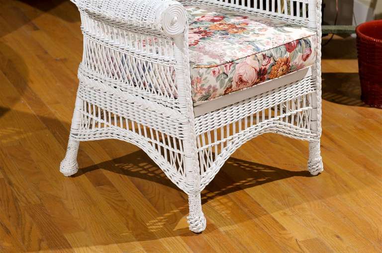 This is a wonderful example of an American wicker chair from the turn of the century.  It is in excellent condition.  Originally the seat was woven.  The seat has been replaced with a wooden one. This would fit in homes on the coast, in the