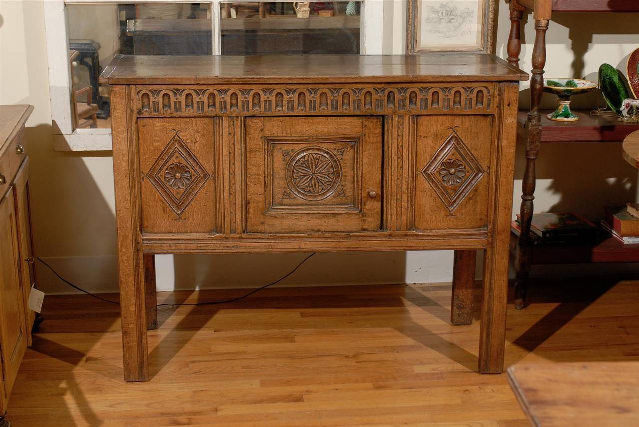 This is one of the loveliest handcrafted 17th c cabinets.  The carvings are beautifully done with great attention to detail.  The color of the oak is mellow with wonderful patina.  This would be beautiful in any home.  The size is perfect for many