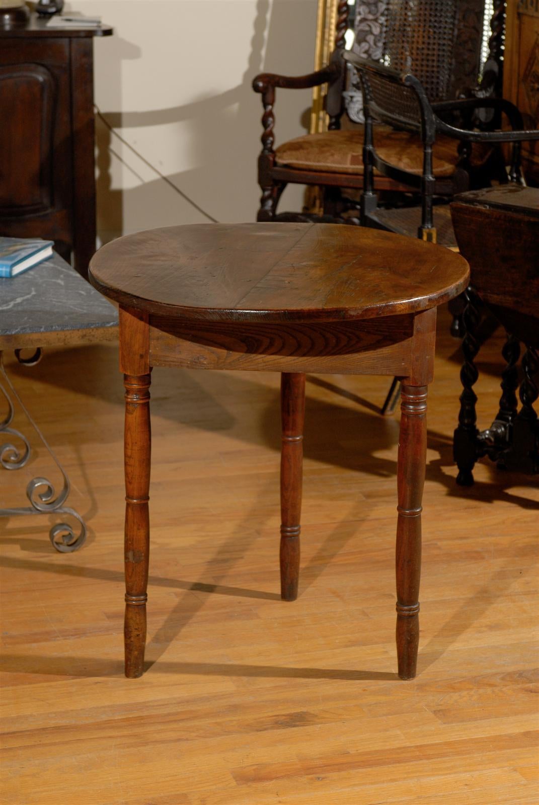 This English cricket table is made of Elm wood in circa 1850.  Cricket tables were always built with three legs for making it easier to balance when  brought out to view cricket games.  This particular table is unique with its turned legs.  Most