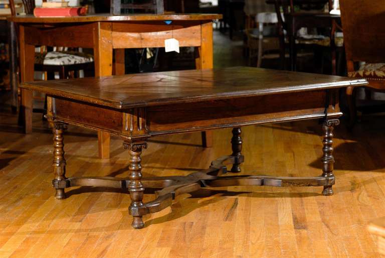 This is a very large oak late 19th century table. It has been cut down to coffee table height.  It has a wonderful pattern on the top. The legs are turned.  It would fit into many homes whether formal or casual.