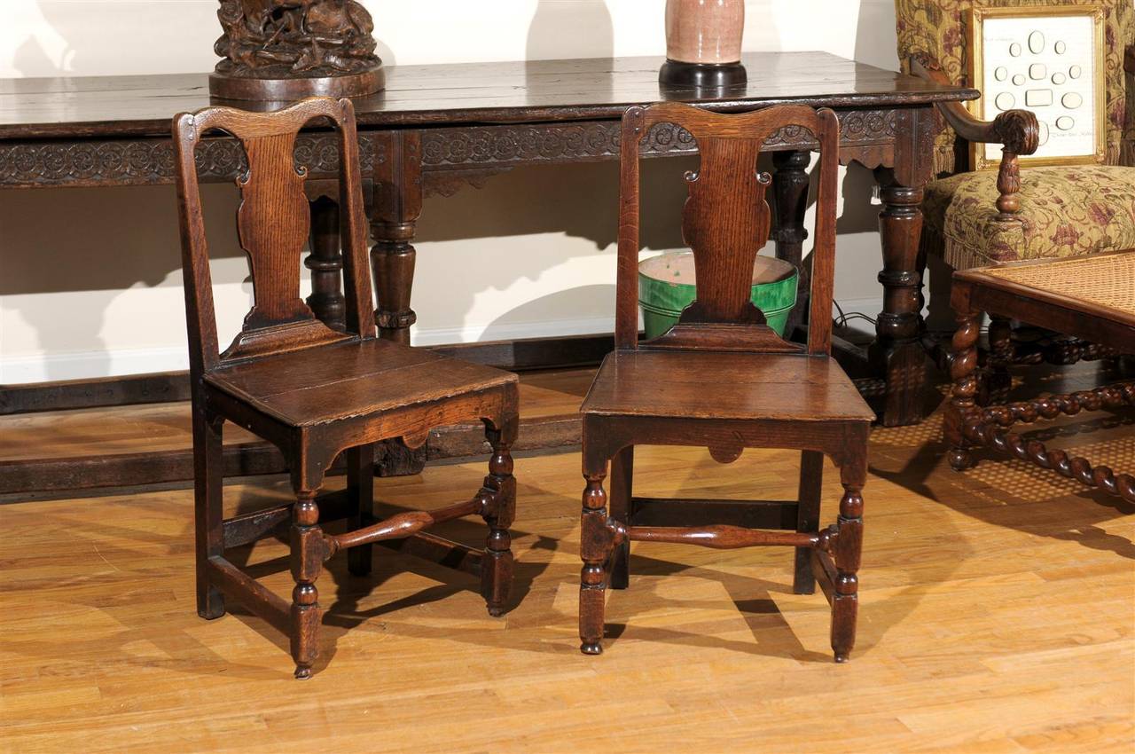 This is a pair of Oak chairs from the 19th century.  These side chairs are from England and would look lovely in any style home.