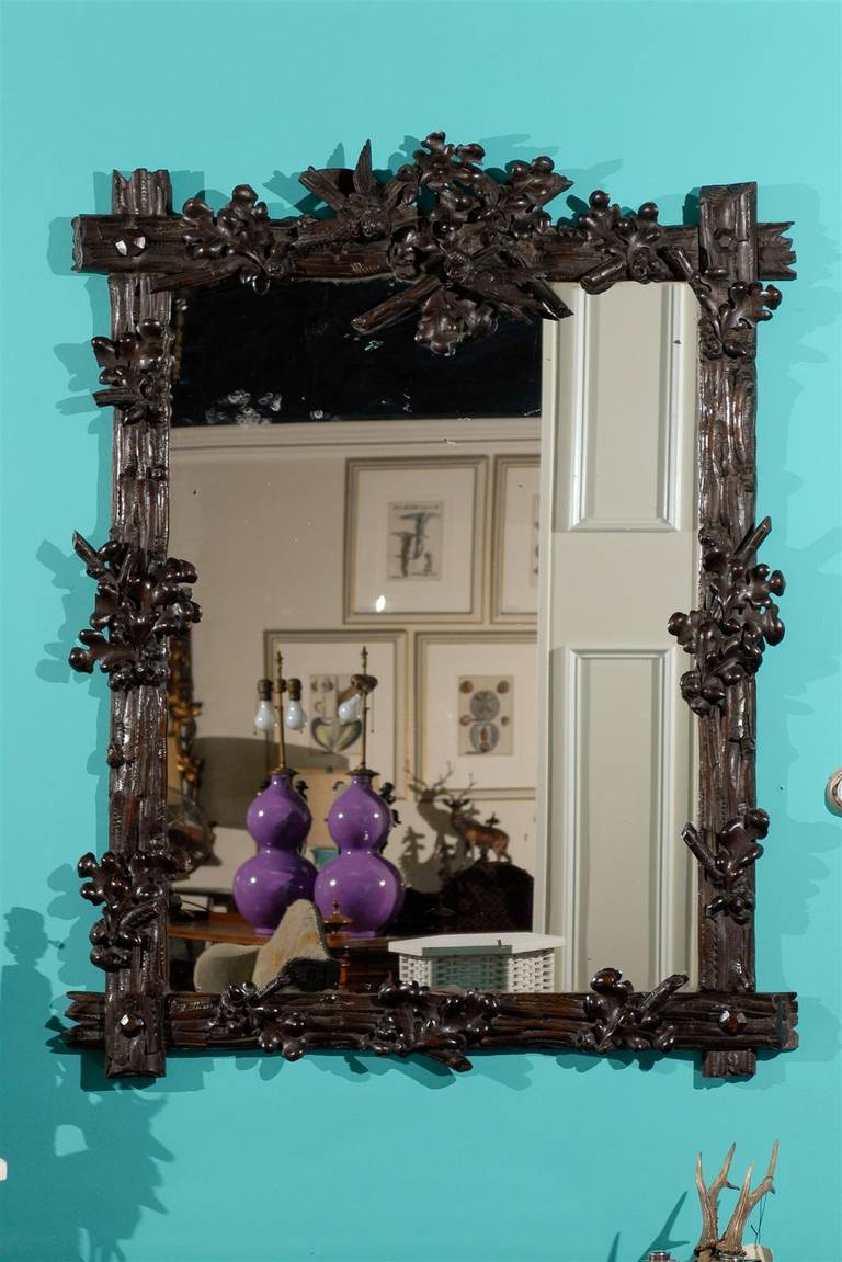 A very large and wonderful Black Forest mirror.  Black Forest wood carved items are very collectable carved out of linton wood.  They were carved in the 19th c by wood carvers from the Black forest area of Germany.