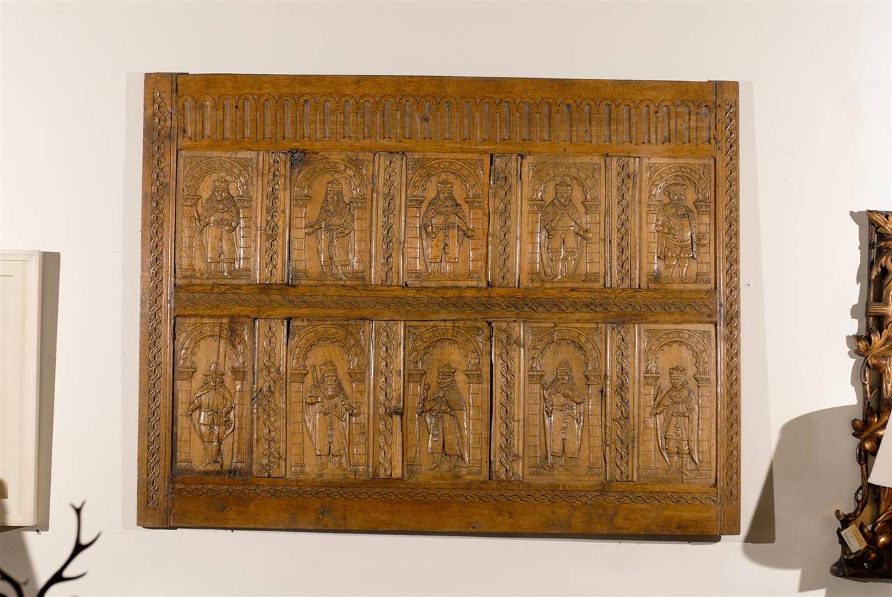 This is a very rare panel with carved heraldic figures. They appear to be bishops. It would be a fantastic piece of art for any home.