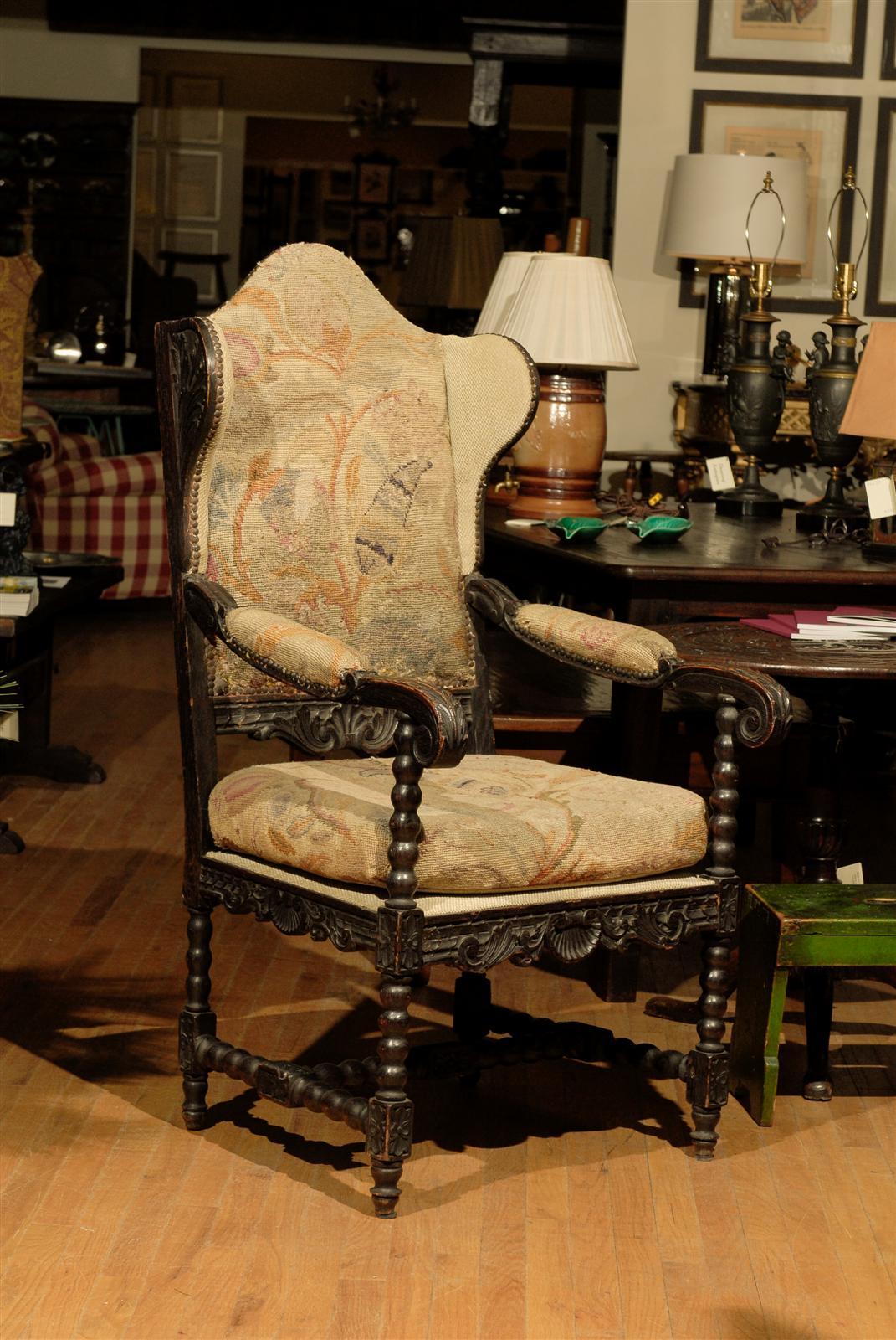 This is a wonderful wing chair with antique needlepoint. The chair appears to be,
Early 1800s. The carving is marvelous. The wings have new fabric. The cushion is in the original antiques needlepoint with new fabric as the seat deck.
This fabric