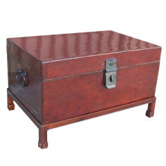 Brown leather trunk on wooden stand