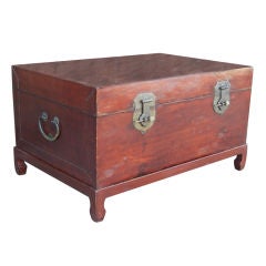 Leather trunk on painted wood stand