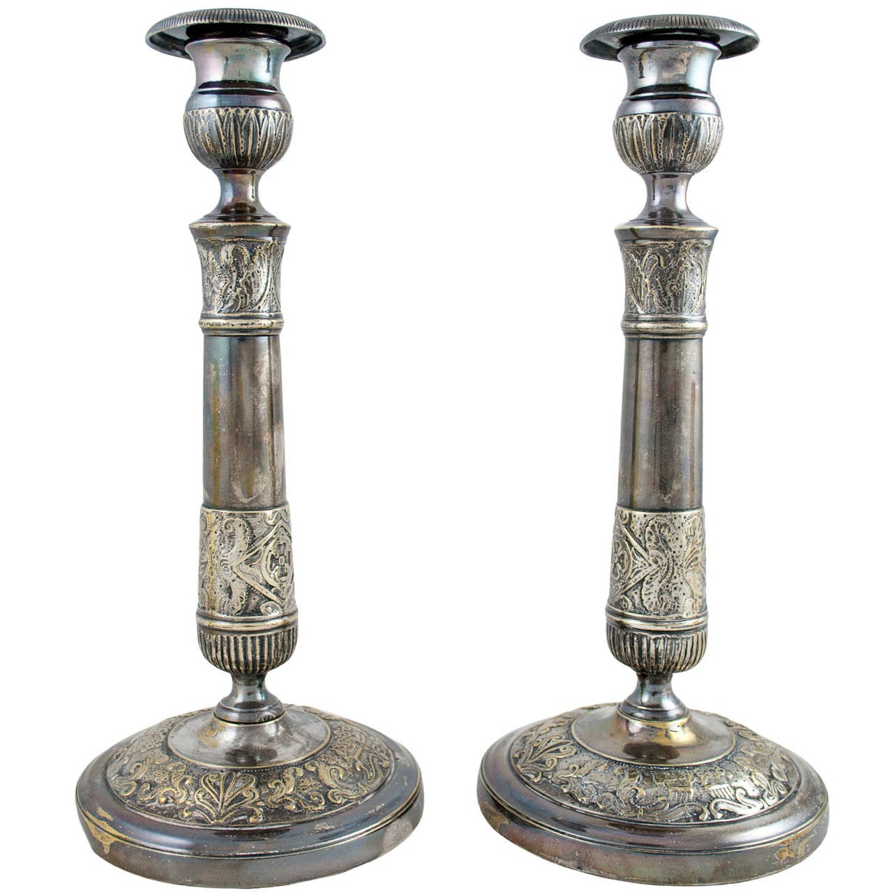 A lovely pair of mid 19th century Empire style candlesticks with Palmette details.
