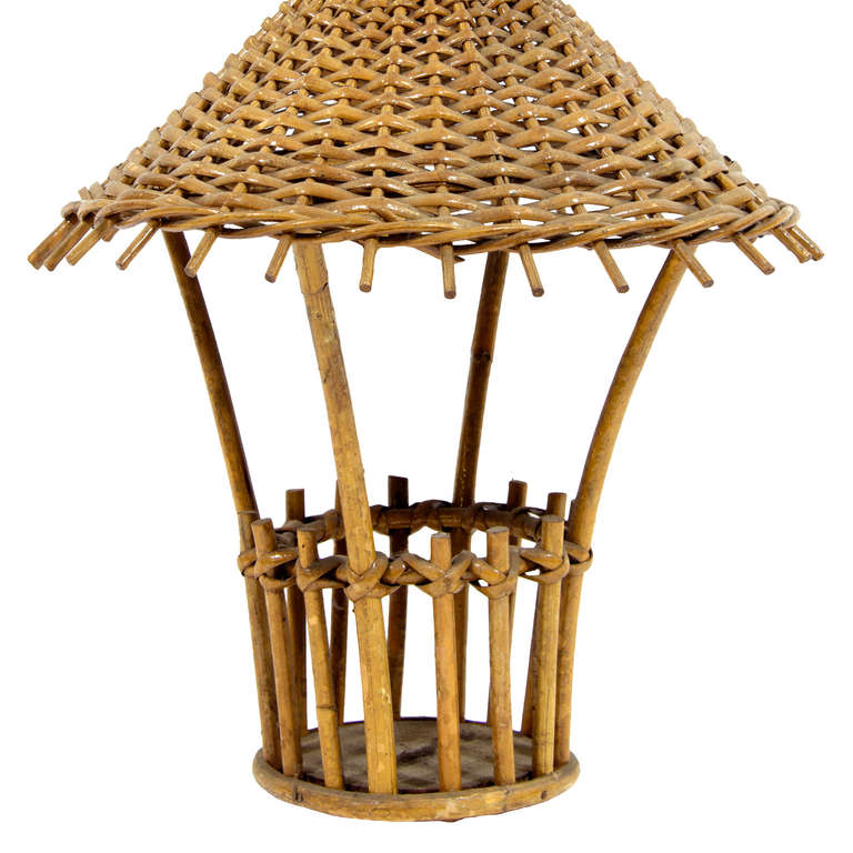 A vintage small rattan sconce in a shape of a lantern.