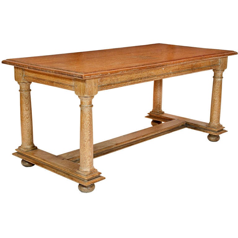 A Cerused Oak Coffee Table Featuring Shaped Column Supports on Bun Feet, Attributed to Jean Charles Moreux.