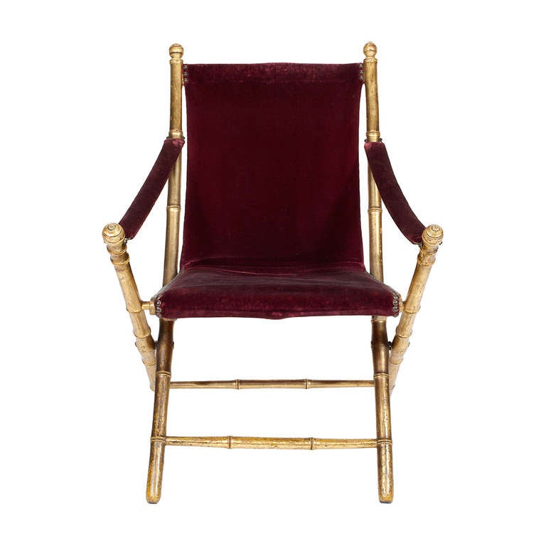 An Italian Giltwood Simulated Bamboo and Original Red Velvet Upholstered Folding Campaign Chair. From the Branca Casa B Collection.