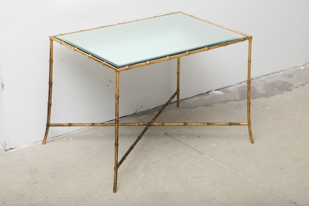 A gilt bronze simulated bamboo base and beveled mirror top side or small coffee table with X-form stretcher, by Maison Baguès.
 