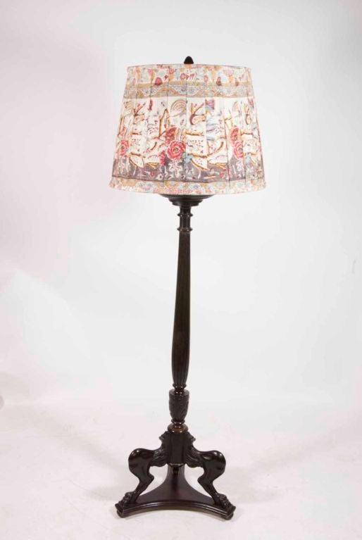 An Empire style mahogany tripod base torchère later converted to a floor lamp with a Branca custom pleated shade made from a vintage 'Tree of Life' textile.