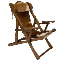 An Alpine Wood Framed and Cow Hide Reclining Chair