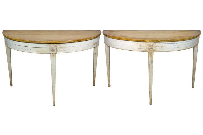 A pair of George III style polychromed demilune side tables with tapered block feet centered at frieze by Carved Paterae.