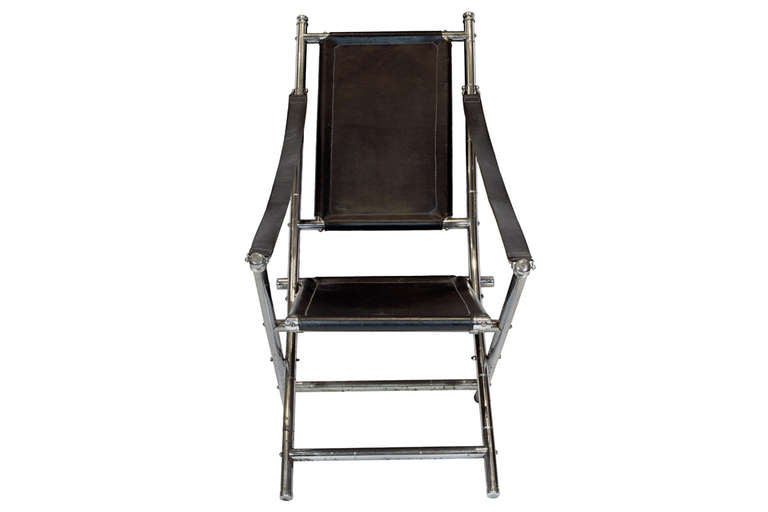 A Mid-Century Chrome and Black Leather Folding Chair, possibly by Maison Jansen.

*Depth from back to front approx. 38''
