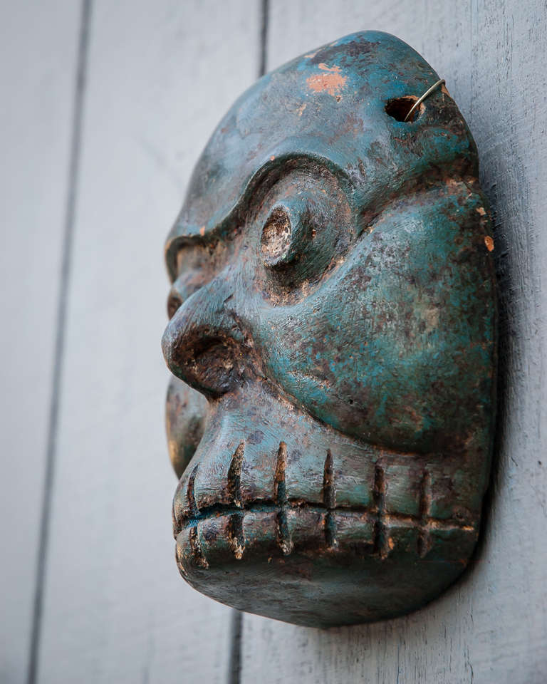 Vintage Fifties Mexican Mask. Green death skull.
Mid-century ceramic visage with rich patina. Macabre death figure of gaunt valleys and death banks bathed in blue and acid-green tones. 
Two others available to form compelling trio, see final pics