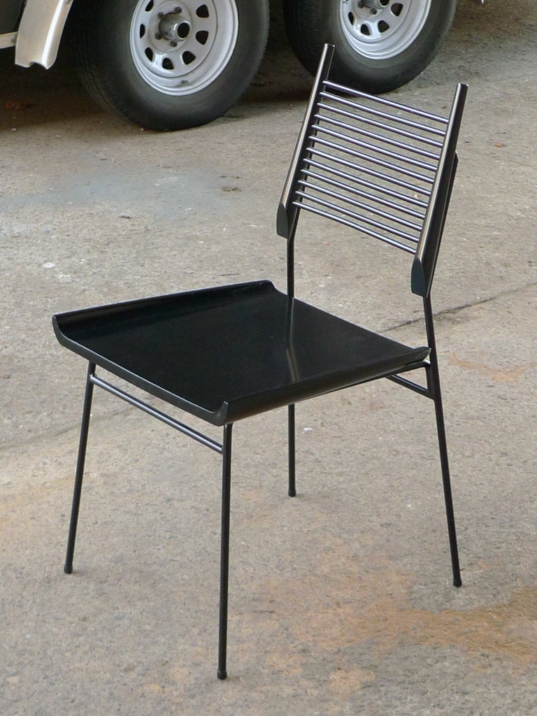 Sculptural Paul McCobb ladder-back,sled-seat chair.
Black wood seat and dowel back with rod-iron legs
