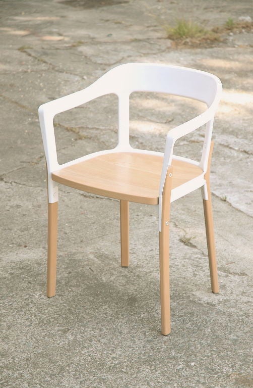 Dynamic marriage of contrasting materials results in unconventional chair.   Composed of natural finish solid beech wood seat and legs that will warm with age as would a country kitchen chopping block and space age white steel frame which will
