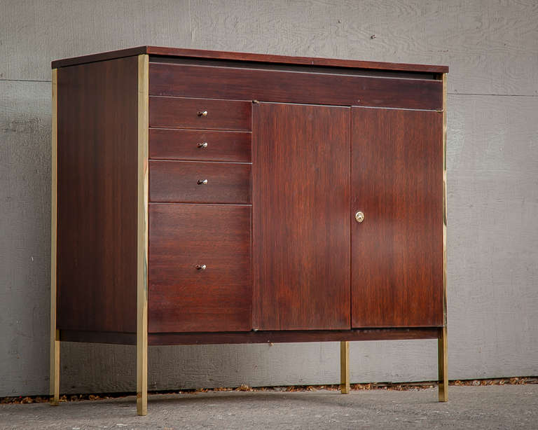 McCobb Sideboard/Liquor Cabinet
Handsome and compact storage unit with walnut body, architectural polished brass uprights and biomorphic nickel plated pulls
Handy lift-up top for entertaining with elegant hinge and user friendly laminate