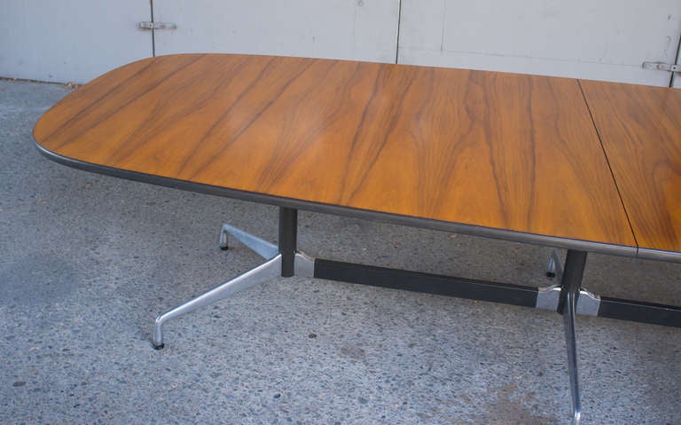 Charles Eames Segmented Base Table for Herman Miller 1964.
Large 2 piece conference table with dramatic grain Walnut top and bullet proof segmented aluminum base.
Classic lozenge form presaging today's mac and general design world penchant for