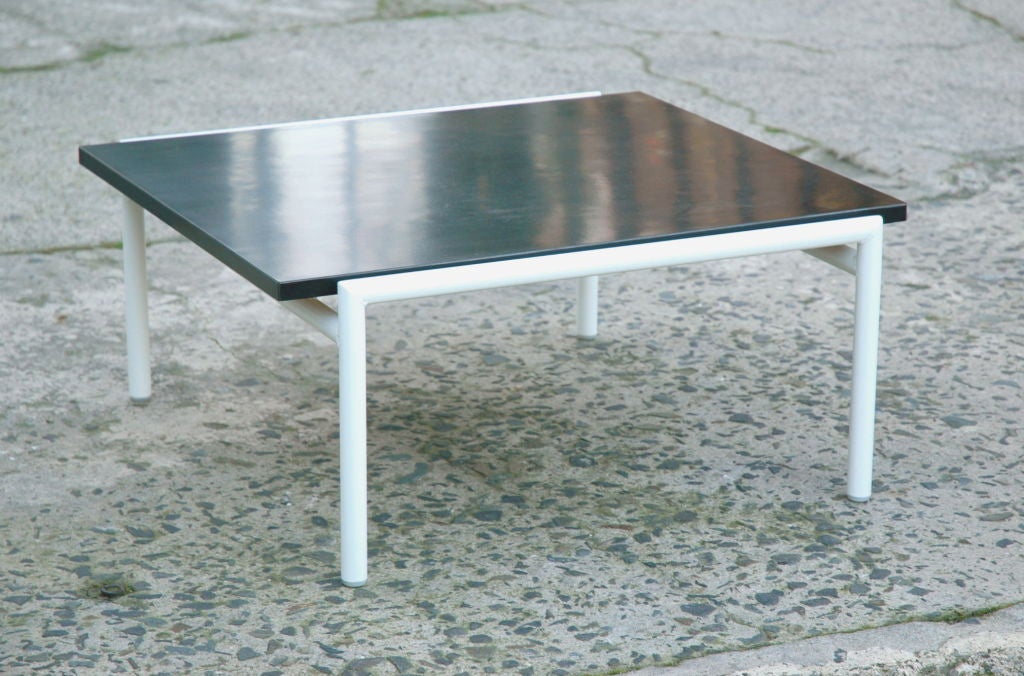 Architectural vintage coffee table with black top and white base by California mid-century architect Don Knorr.  Knorr designed for Aero Saarinen, helping to develop Knoll's classic of American postwar industrial design-the fiberglass back chair
