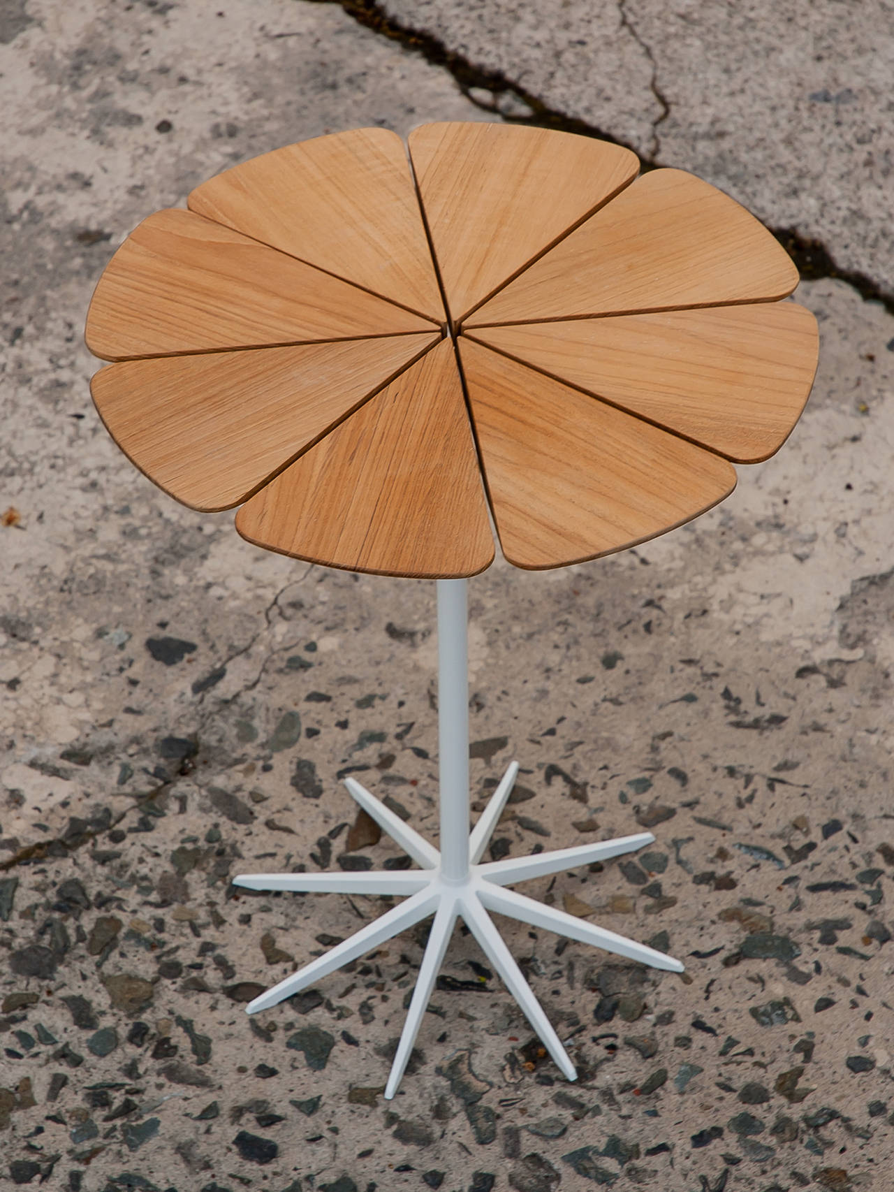 Current Knoll production example of Richard Schultz teak/white 1960 petal side table for Knoll.
Indoor/Outdoor petal coffee table with wood top appropriate for outdoor use atop delicate spidery support system.
Knoll Reissue of this classic member