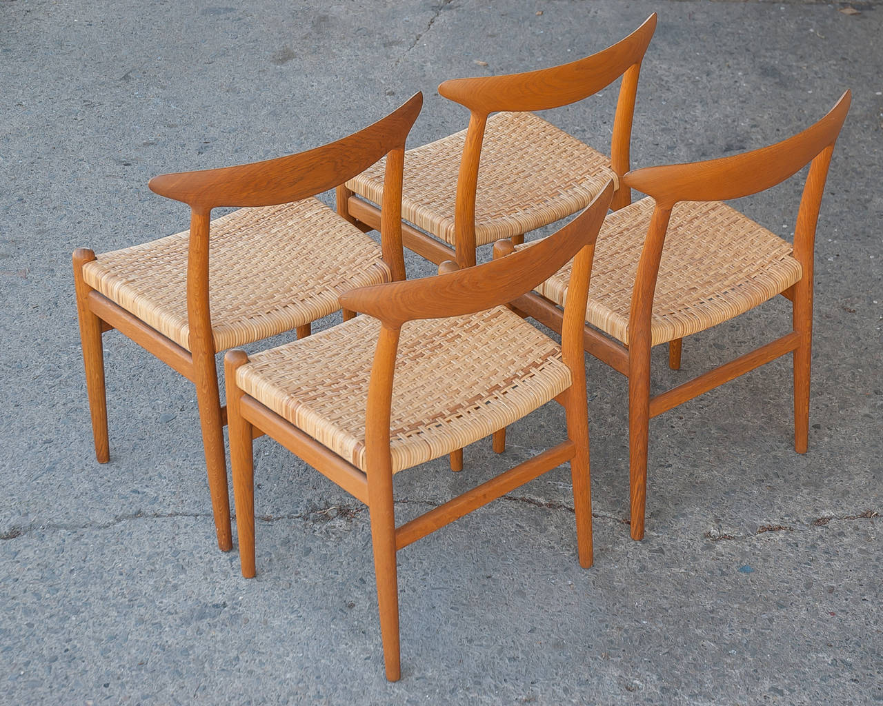 Hans Wegner vintage dining set/four chairs with wood frame and cane seat.
Hans Wegner, “Heart Chair,” for CM Madsens, 1953, Denmark.
Flat banana back form with replaced cane seats.
Solid oak frames restored with natural oiled finish with newly