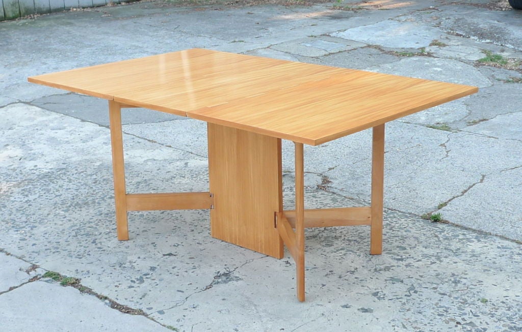 Herman Miller #4656 double drop leaf dining table in striking Primavera wood.  Handsome classic Nelson design affords an elegant console which can line up with other Nelson cabinets or serve as solid dining table with stable base and generous table