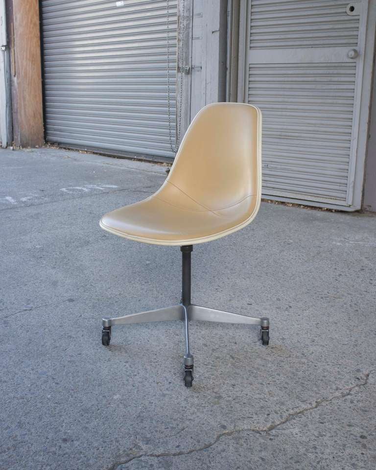 Charles Eames for Herman Miller vintage vinyl covered side-shell on Aluminum-Series star base with heavy duty rubber and steel casters. 1953/1961
Vinyl Mustard seat and back with cream trim.  Because vinyl does not breathe, high density latex foam