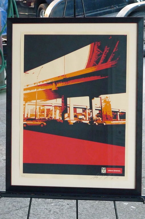 Screen-print in red, black and yellow depicting urban scene under bay area freeway. Part of the Urban Renewal Series by Shepard Fairey executed in 2001; 58/200. Signed and numbered in pencil by artist.
22.5”w 28.5”ht;  Image/sheet: 18”w 24”ht