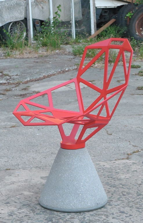 Futuristic red metal chair with cement cone base by Konstantin Grcic for Magis, 2004. Swivel base with self-returning mechanism.

The quintessential Grcic design, Chair One encapsulates a strain of today's flamboyant high tech design sensibility