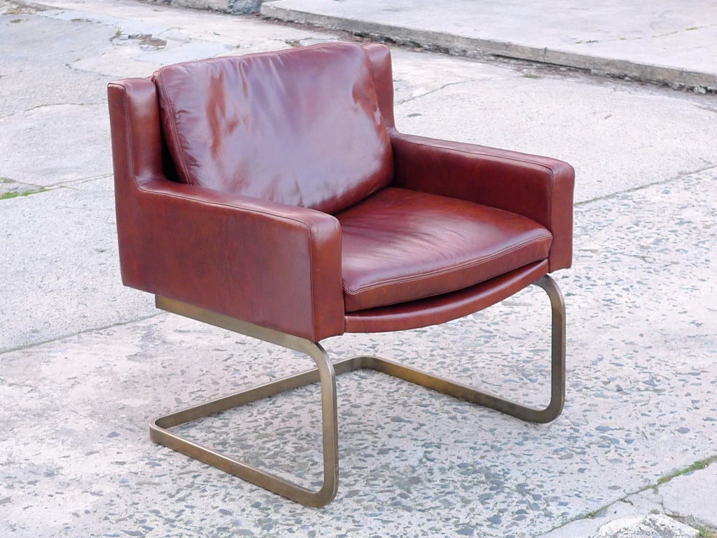 Stendig 1148 Xanadu leather arm chair with extremely supple new leather.  Original patina to brass wash cantilevered base  Also available as a pair for $6300.