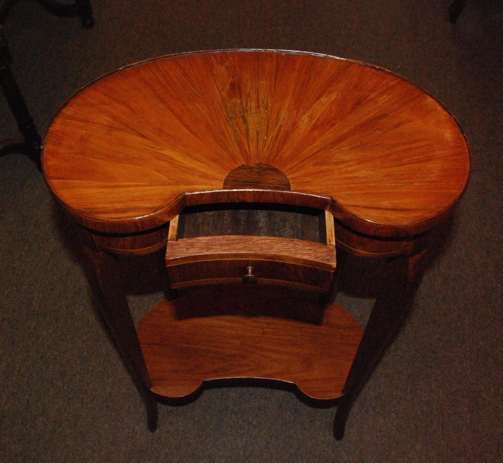 Antique French mahogany inlaid with satinwood and kingswood kidney shaped table with center drawer.
