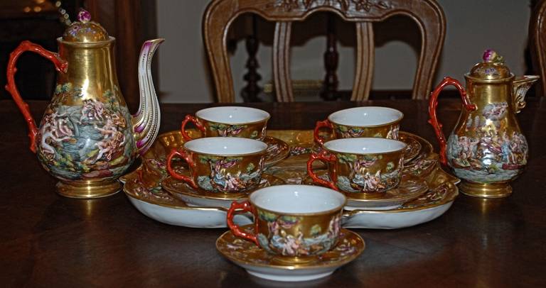 Antique French Capo Di Monte coffee set containing five cups, servers and tray.