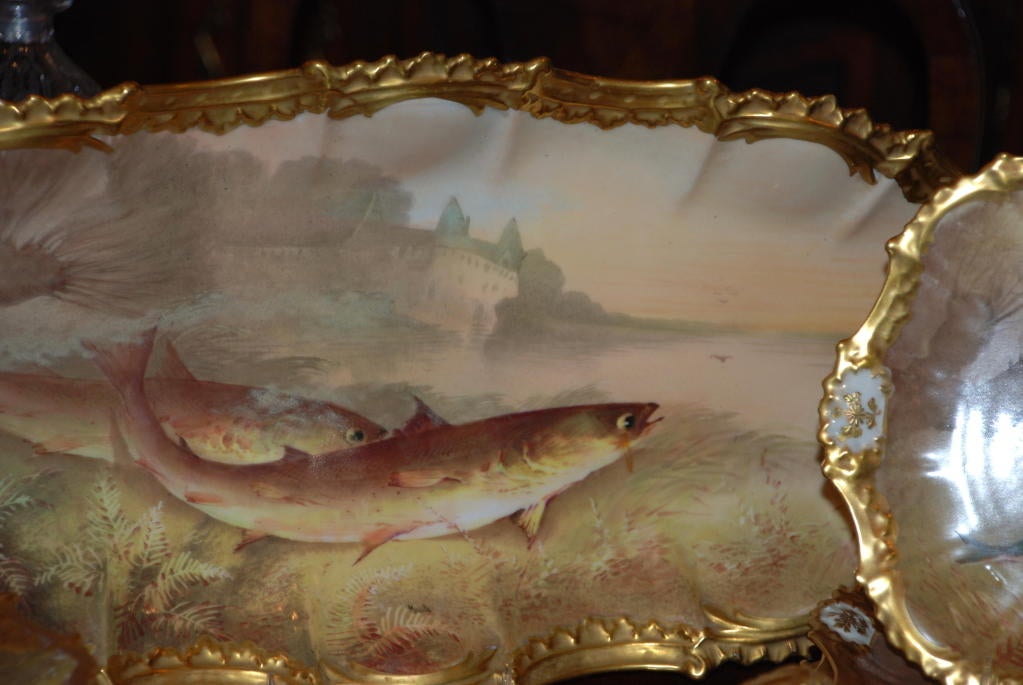 Antique French Limoges porcelain fish set, platter, 12 plates and sauce boat.