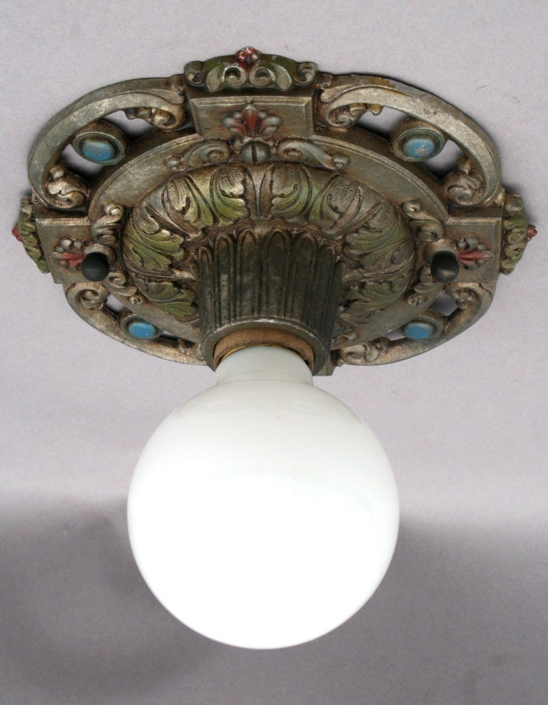 Beautifully cast ceiling fixture c. 1920's with original polychrome finish highlighting the detailed cast design