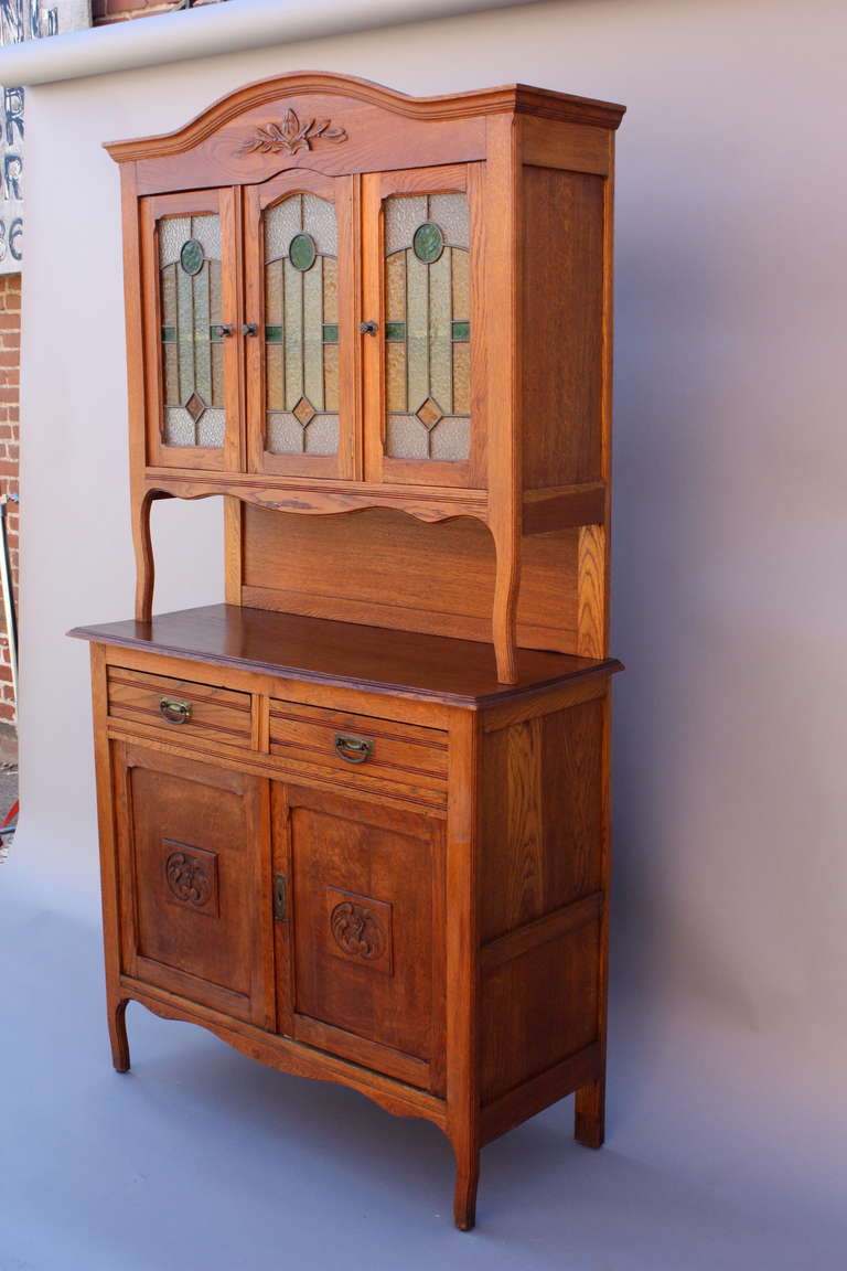 Turn of the century European cabinet with beautiful stain glass doors. Two drawers Oak.