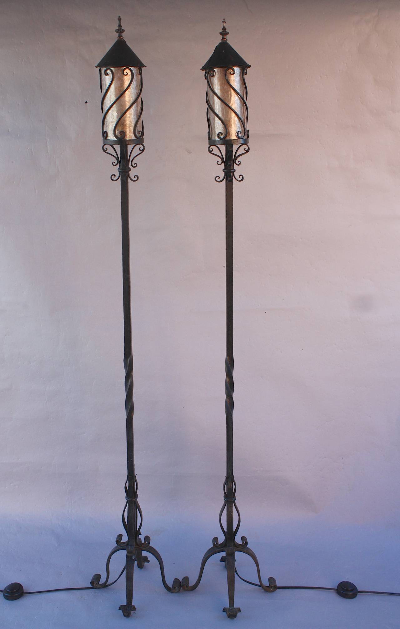 Pair of wrought iron torchieres with new mica, circa 1930s. Wrought iron construction. Dimension: 12