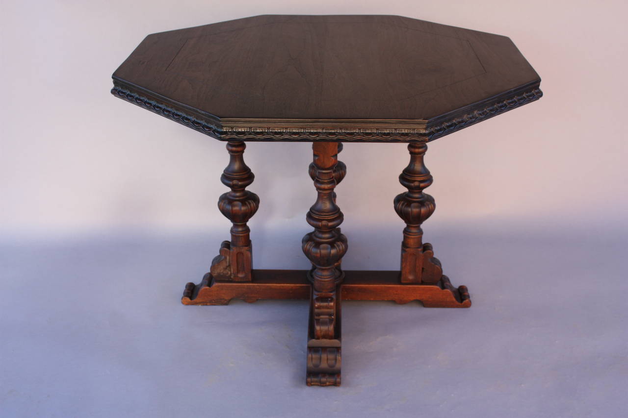 Octagonal table top is supported by four carved legs, circa 1920s table. This table could be used as game table or breakfast table. Dimension: 41
