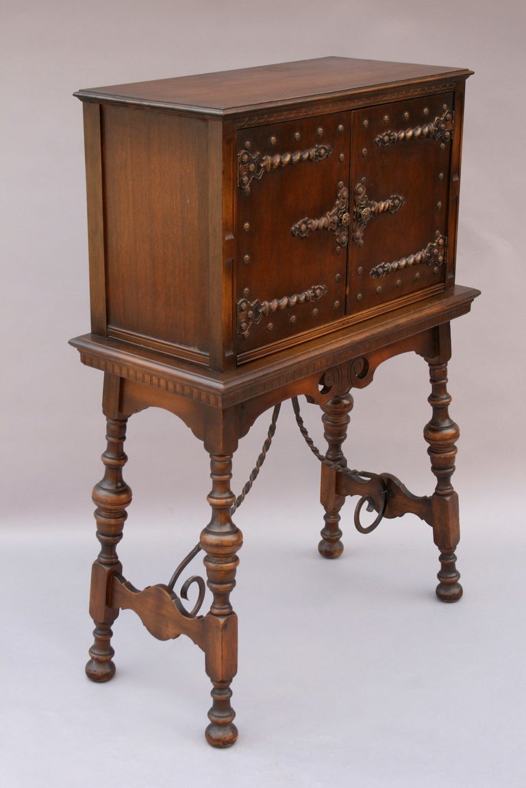 Pristine 1920's Angelus Furniture Manufacturing Cie Writing desk. Made in Los Angeles.  Oak. Wrought iron stretchers.  Doors open to storage and the writing tablet slides out.  Very space efficient for a guest bedroom. 