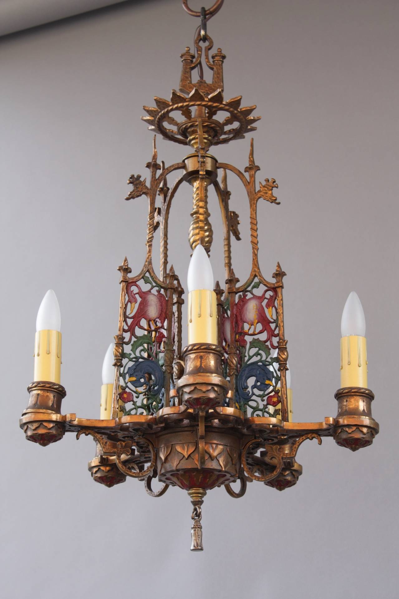 Imposing and whimsical chandelier with original polychrome finish and bird motif. Body of fixture is 29.75