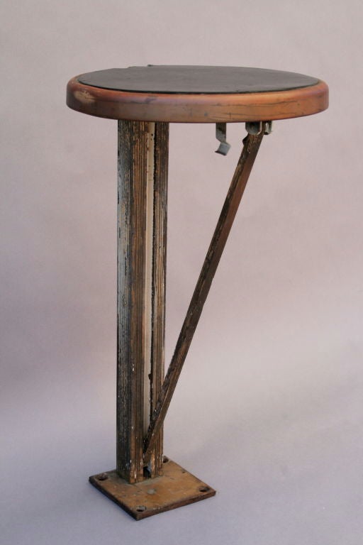 Originally created to give elevator operators respite when times were slow.   Today, this imaginatively designed floor mounted folding stool can be used as a special place to sit or even display objects.