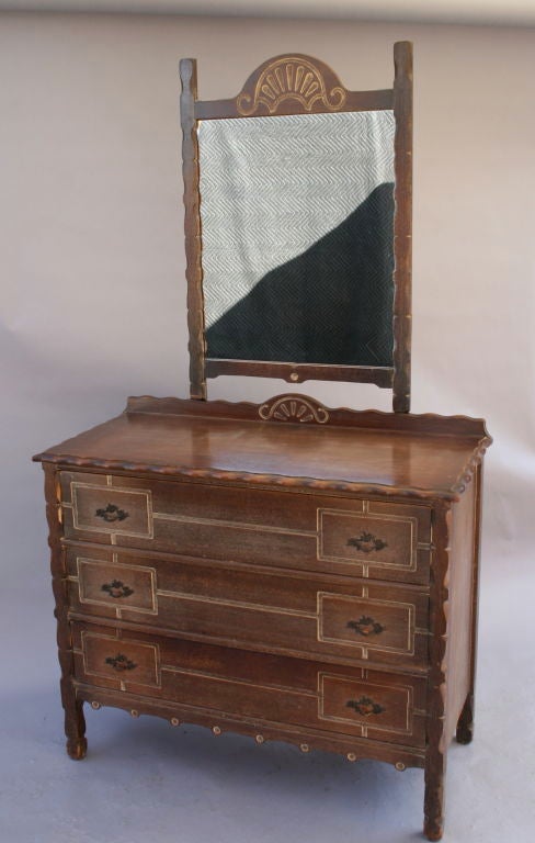 Carved wood dresser with coordinating mirror. A classic example of the mediterranean influence in architecture and design in the California 1920's.