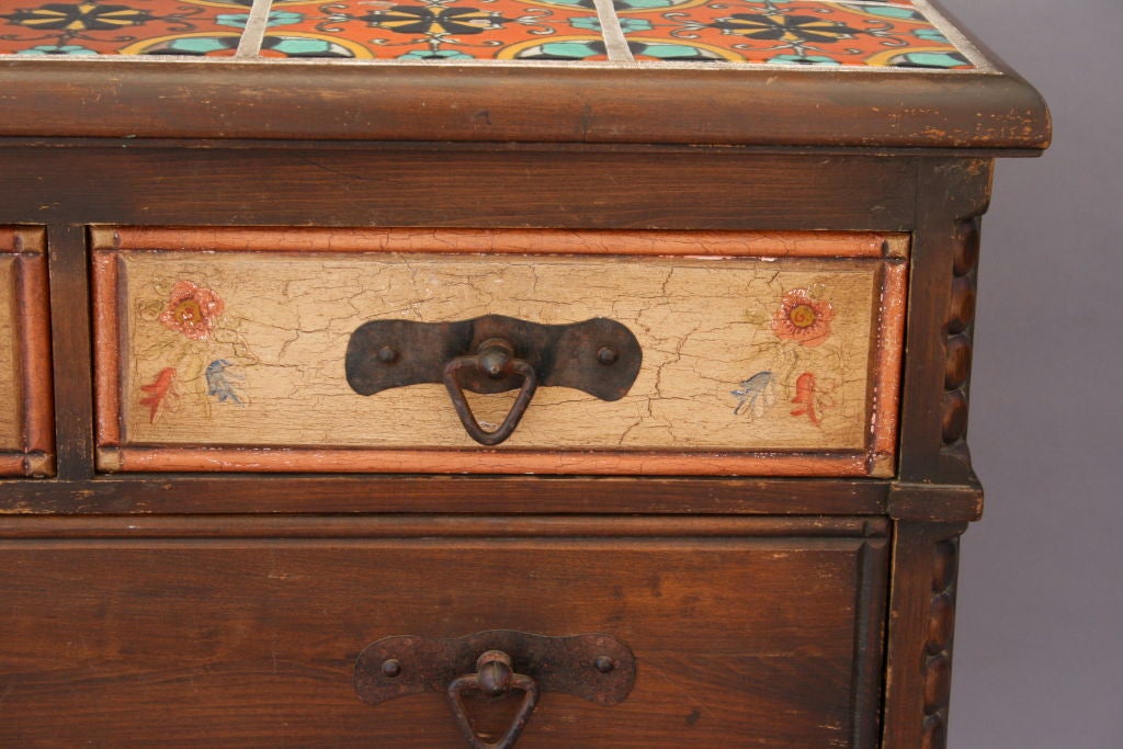 Wonderfully crafted dresser with hand-painted details, Hispano Moresque tiled top, and absolutely great iron hardware! Four drawers; coordinates w/ night stand #3755