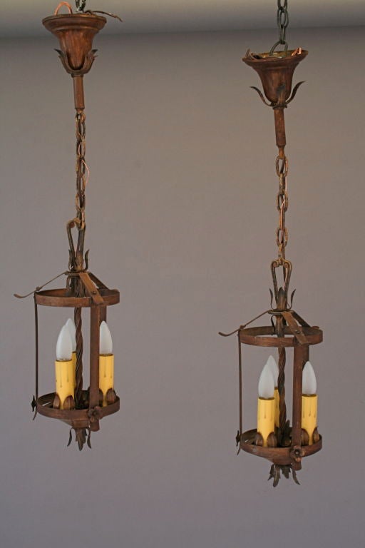 Sold individually. 1920's three light pendant with acanthus and floret details.