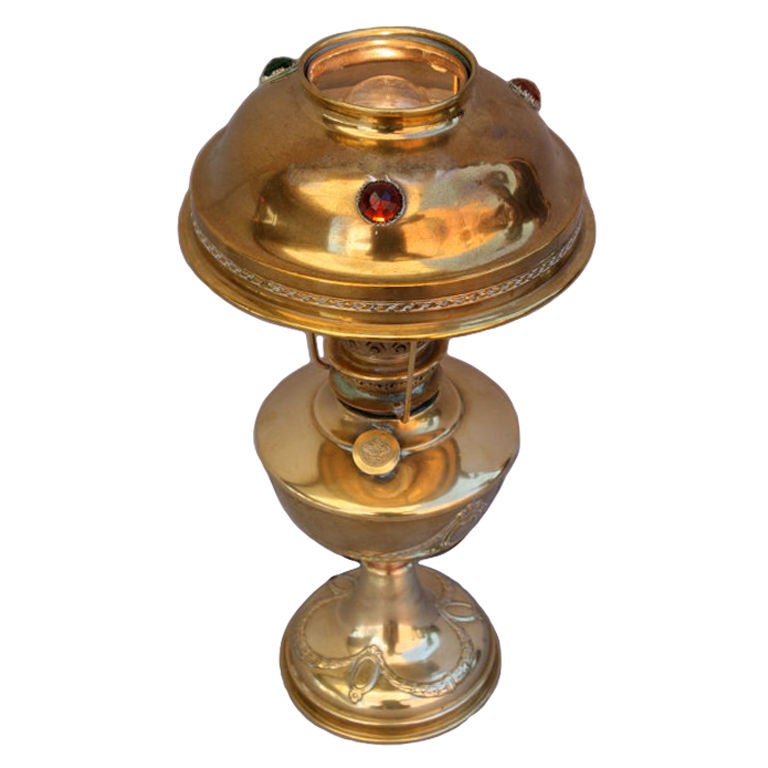 Polished brass Art Nouveau table lamp with faceted jewels encircling the shade.  Beautiful polished brass with repeating wreath and garland pattern.