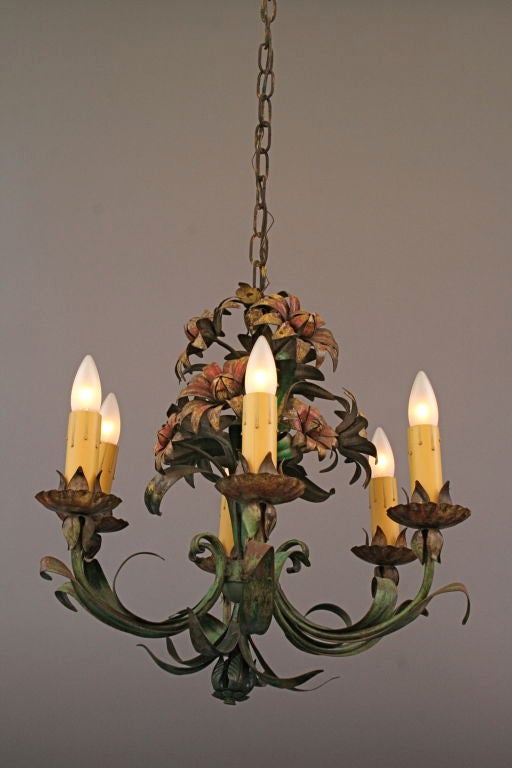 Whimsical Italian chandelier with bouquet of blooming flowers.