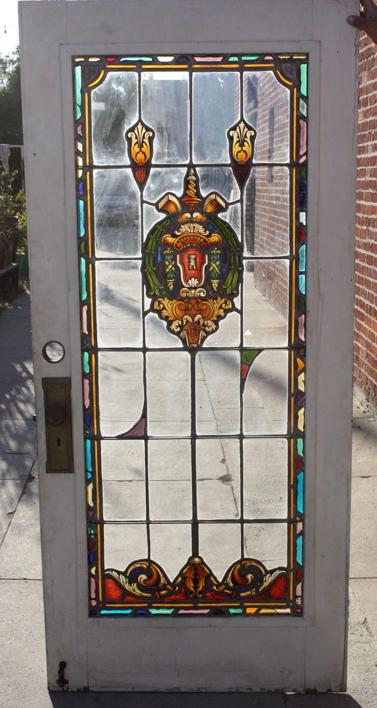 Rare 1920's Spanish Revival door with exquisite hand painted  stained glass. Salvaged from local Los Angeles home,